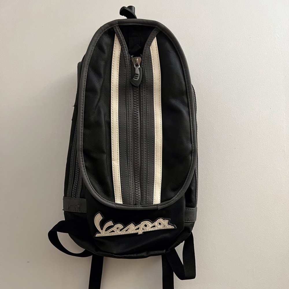 Vespa Black Backpack with multiple pockets, heavy duty zippers. Faux leather